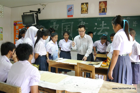 学生们认真地和老师学书法.jpg