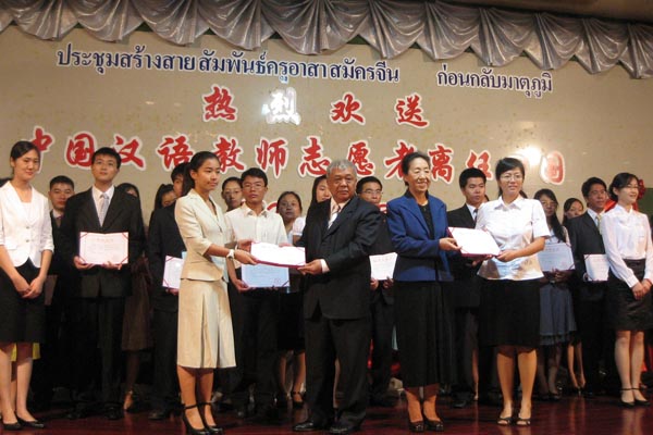 泰国教育部部长顾问苏拉铁与国家汉办驻泰代表庞利为优秀志愿者办法证书
